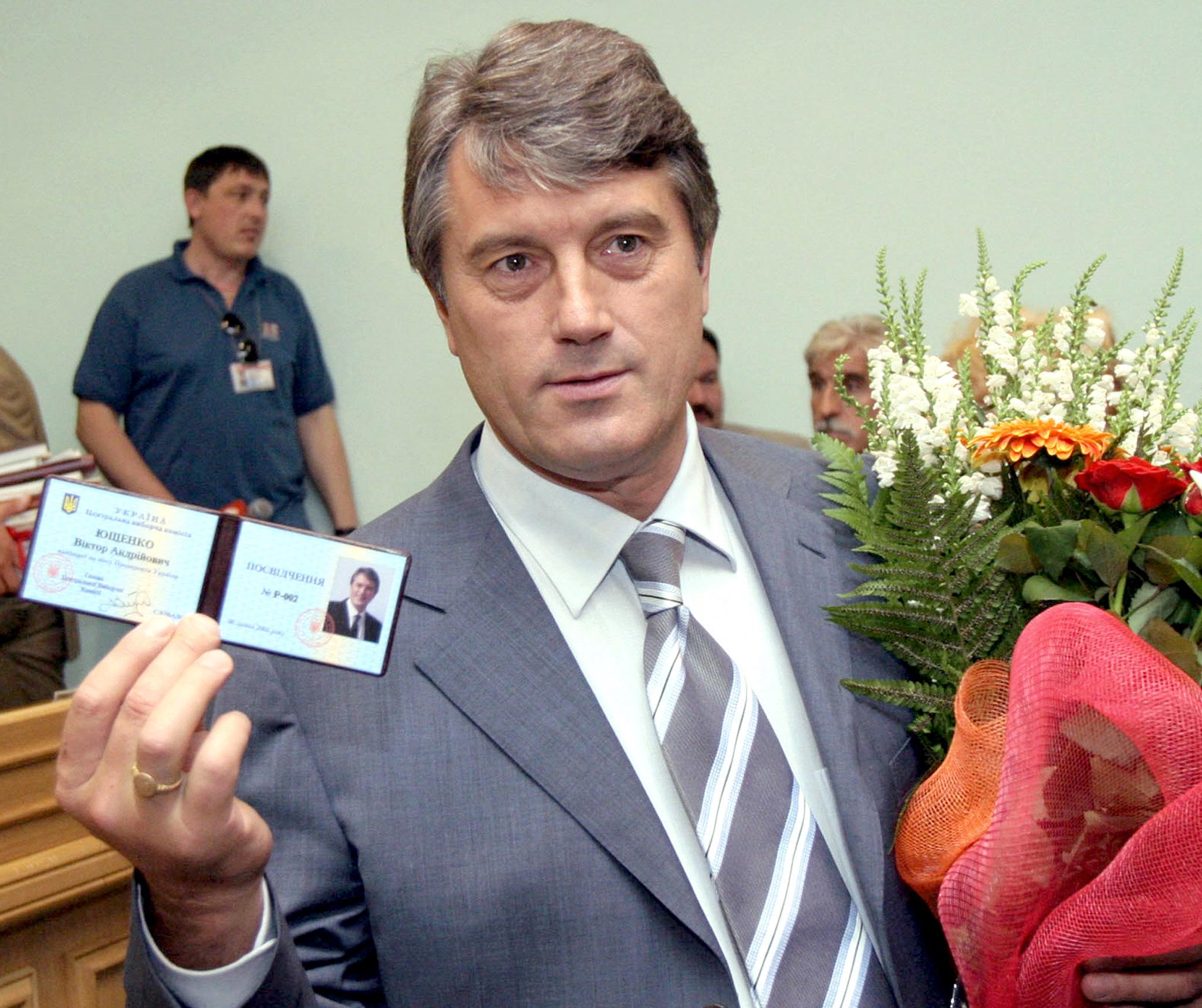 Viktor Yushchenko, an opposition candidate currently favourite to succeed outgoing President Leonid Kuchma in an October presidential election shows his presidential candidate's certificate, which he received from the central elections commission in Kiev 06 July 2004.  The vote will produce the first new head of state in a decade for Ukraine, the biggest country in Europe in area after Russia. Kuchma, in power since 1994, has said he will not run again. AFP PHOTO /POOL/ Anatoliy MEDZYK/ ss (Photo by ANATOLIY MEDZYK / POOL / AFP) (Photo by ANATOLIY MEDZYK/POOL/AFP via Getty Images)